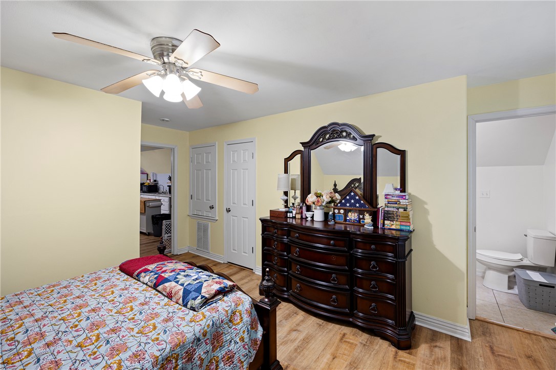 751 Walthall Road Russellville, AR 72802 - Photo 48 of 60 Bedroom featuring wood-finish flooring, a ceiling fan with integrated lighting, and light-toned walls