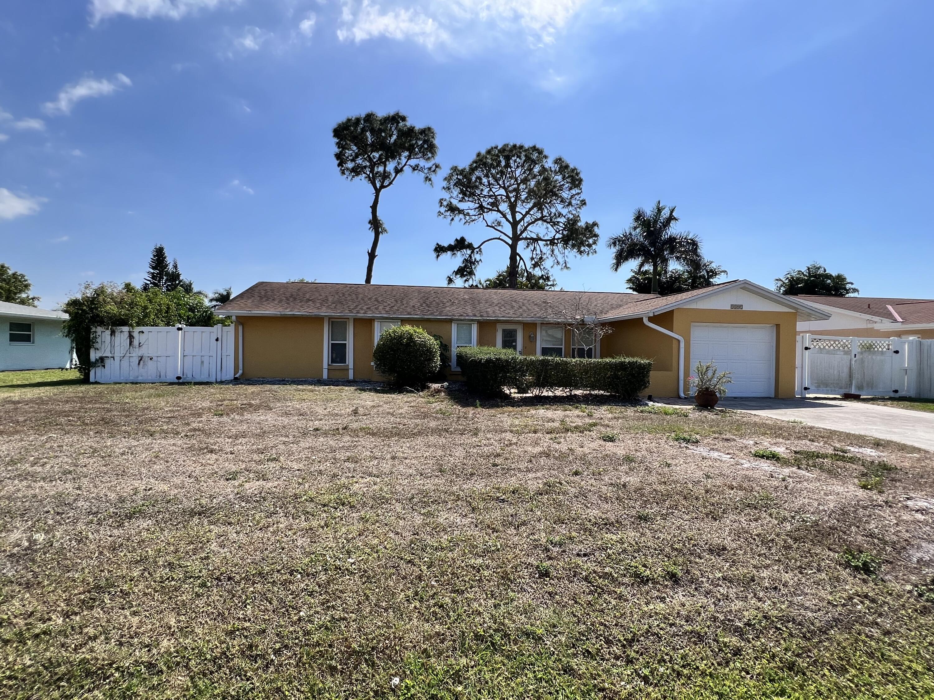 2392 Clipper Way Naples, FL 34104 - Photo 1 of 29 a front view of a house with a yard and garage