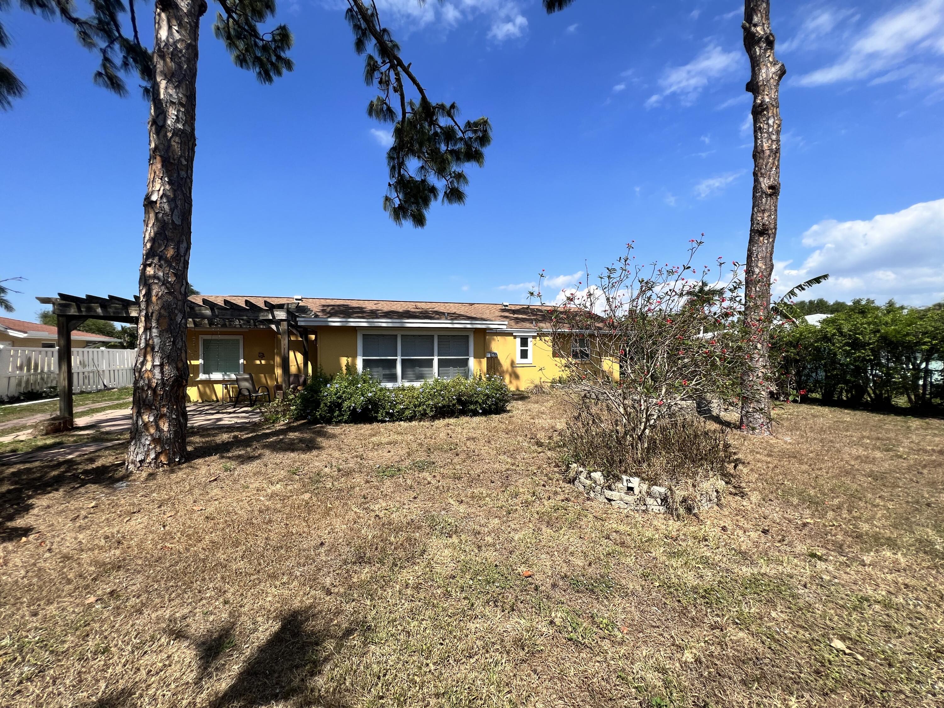2392 Clipper Way Naples, FL 34104 - Photo 11 of 29 a view of a house with a tree in the background