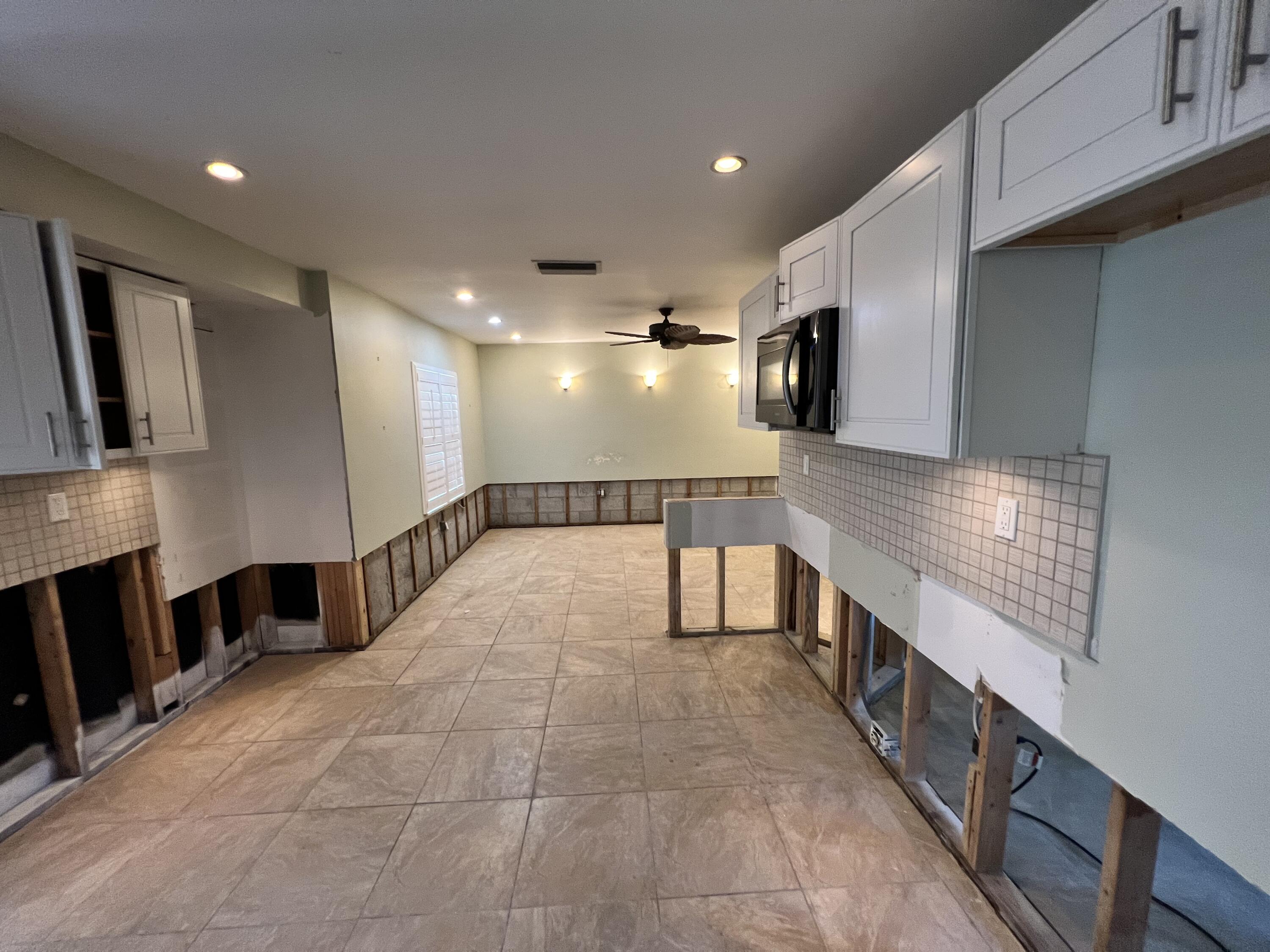 2392 Clipper Way Naples, FL 34104 - Photo 15 of 29 a large hall with stainless steel appliances granite countertop a large stove top oven and cabinets