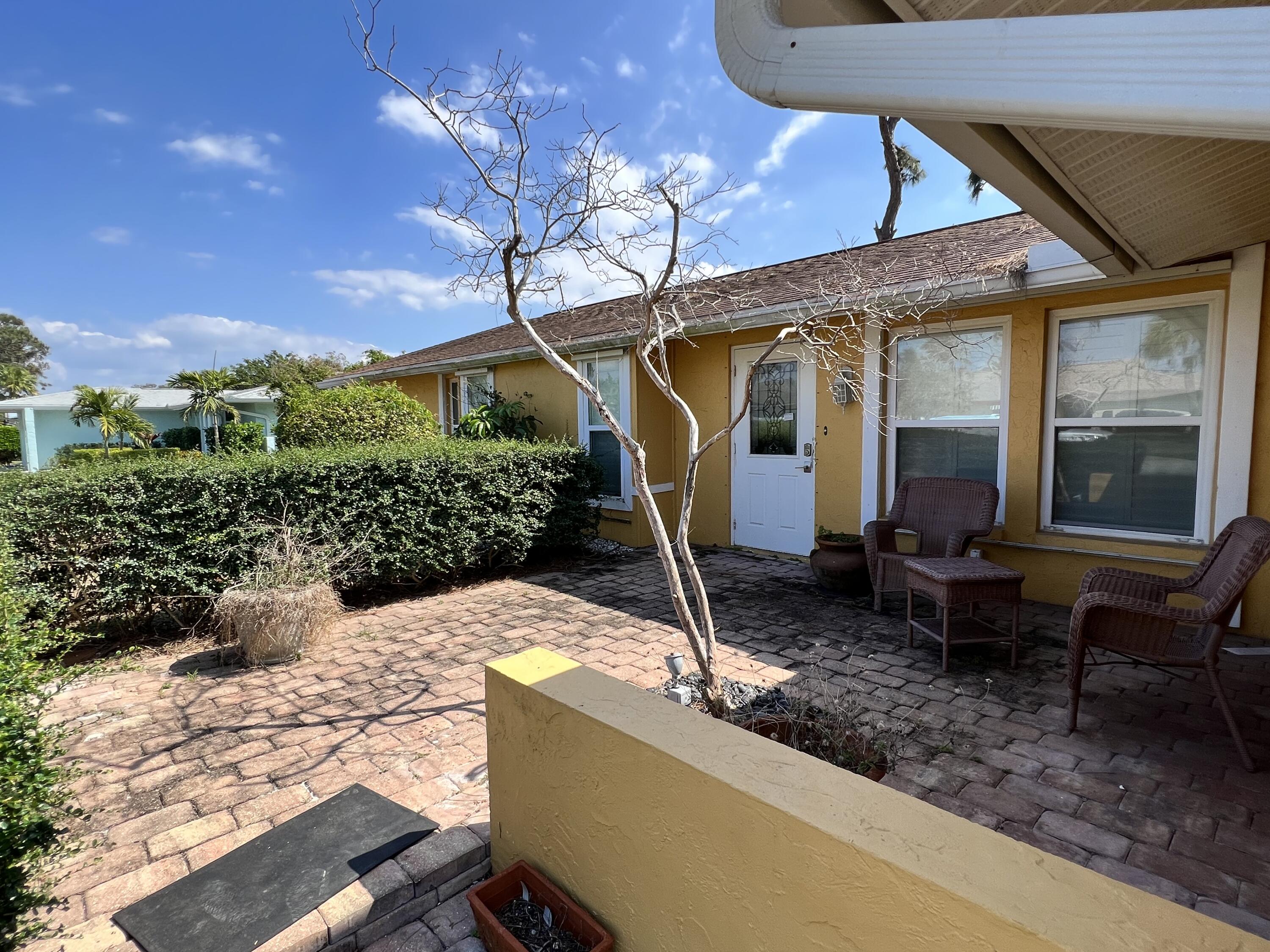 2392 Clipper Way Naples, FL 34104 - Photo 2 of 29 a front view of a house with garden
