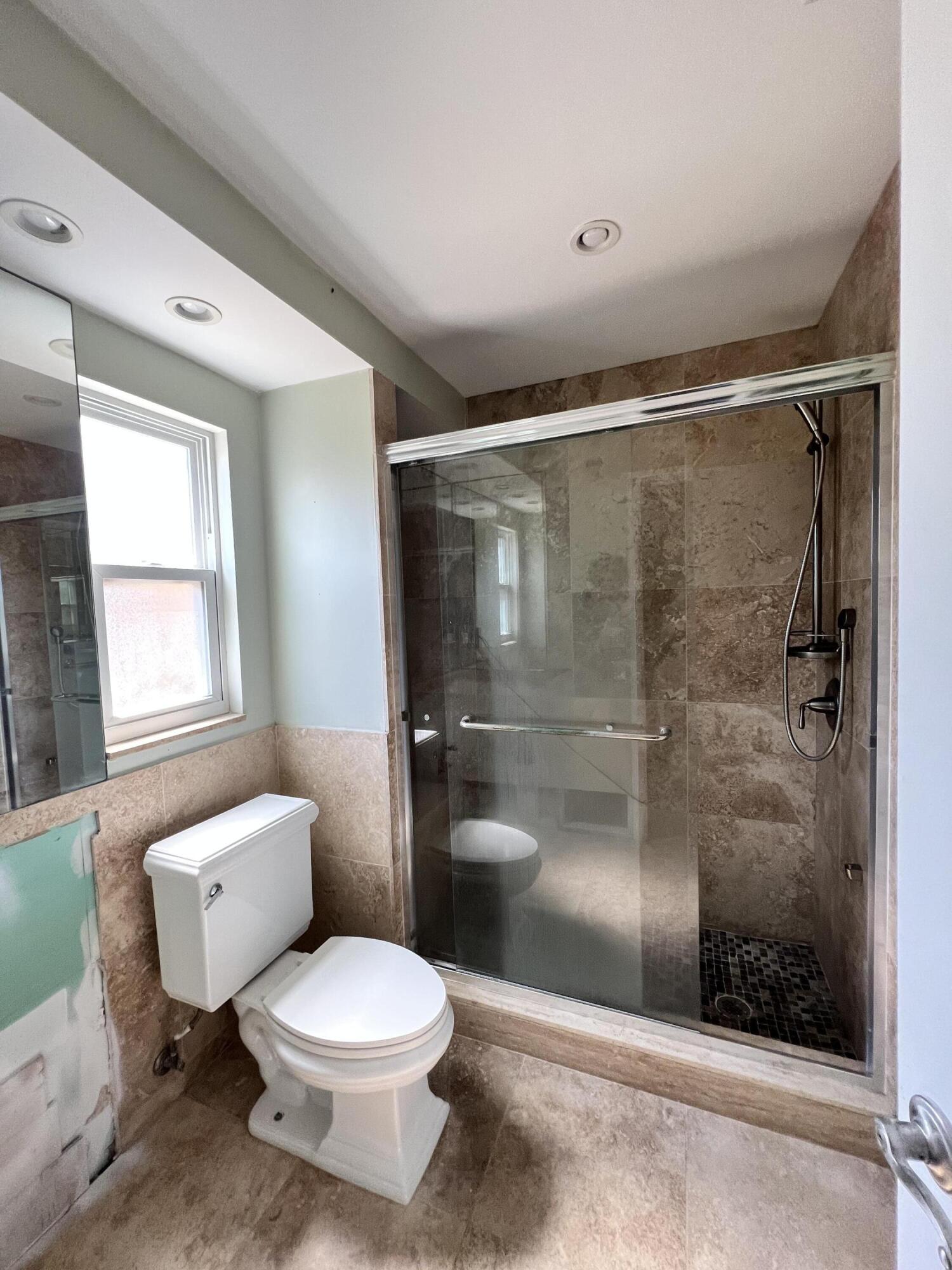 2392 Clipper Way Naples, FL 34104 - Photo 24 of 29 a bathroom with a toilet and a shower