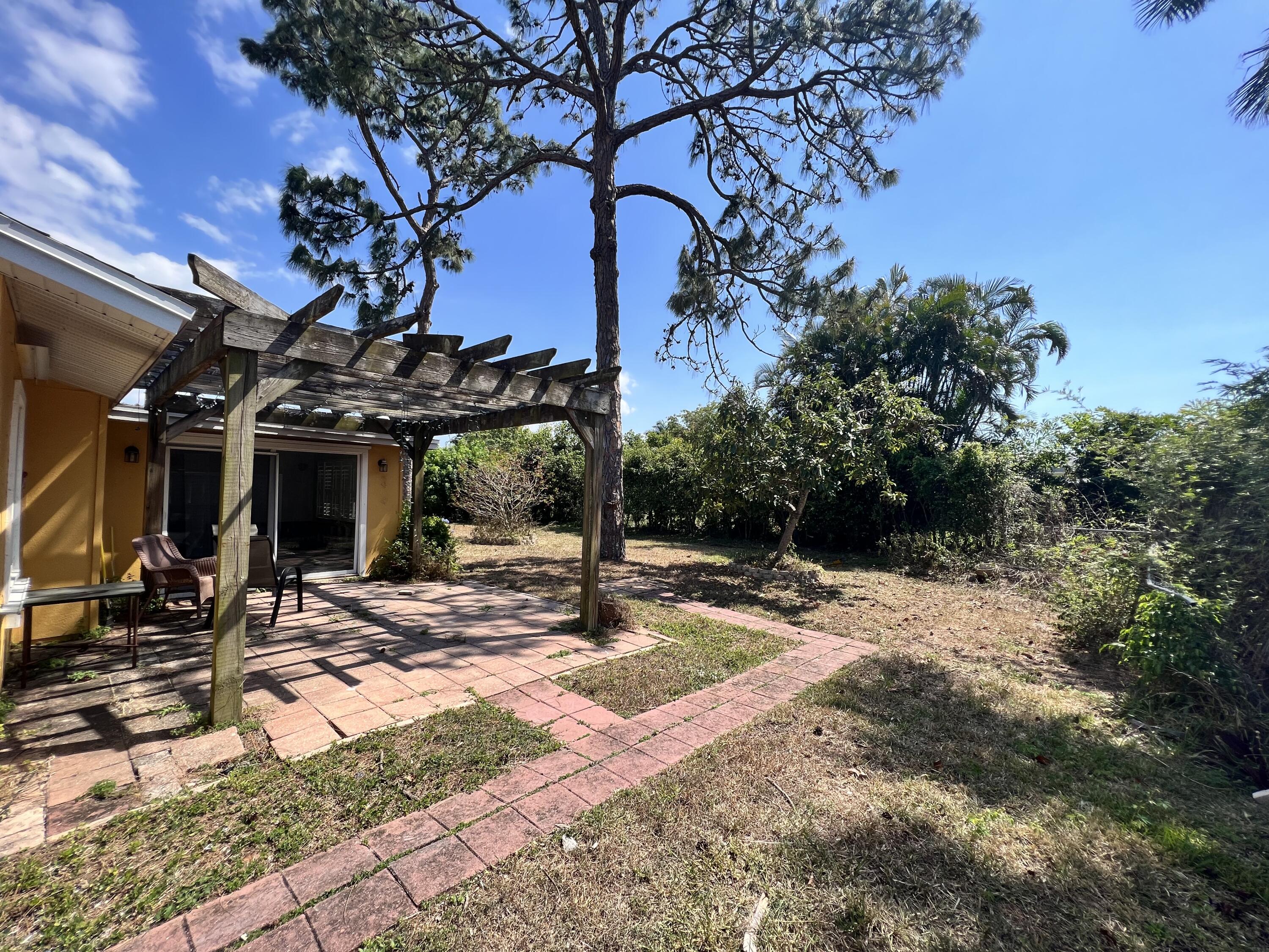 2392 Clipper Way Naples, FL 34104 - Photo 4 of 29 a view of a house with large trees