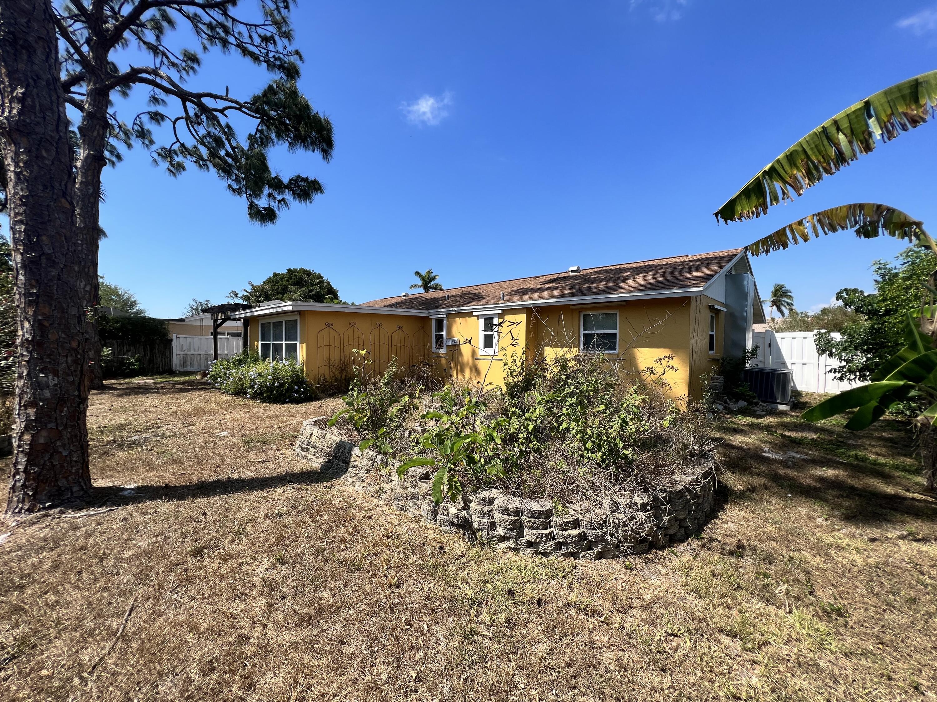 2392 Clipper Way Naples, FL 34104 - Photo 8 of 29 a view of a garden