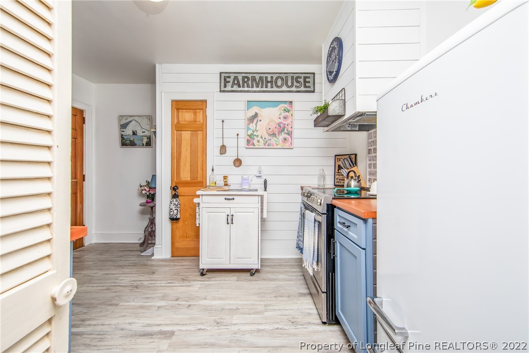 906 McKimmon Road Fayetteville, NC 28303 - Photo 11 of 33 a view of kitchen with furniture and wooden floor