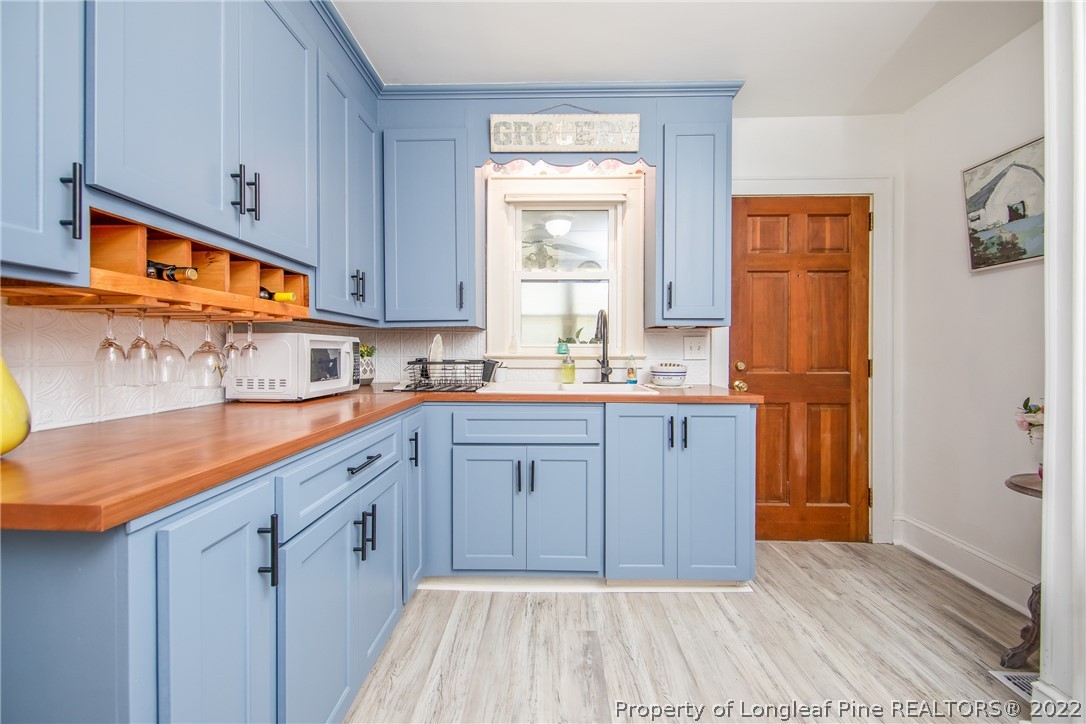 906 McKimmon Road Fayetteville, NC 28303 - Photo 12 of 33 a kitchen with stainless steel appliances granite countertop a sink and cabinets