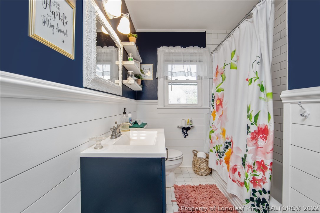 906 McKimmon Road Fayetteville, NC 28303 - Photo 19 of 33 a bathroom with a sink and a window