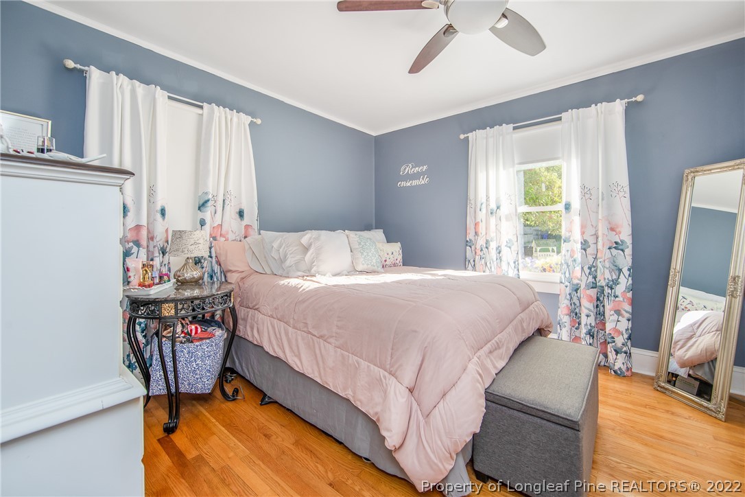 906 McKimmon Road Fayetteville, NC 28303 - Photo 23 of 33 a bedroom with a bed and large windows