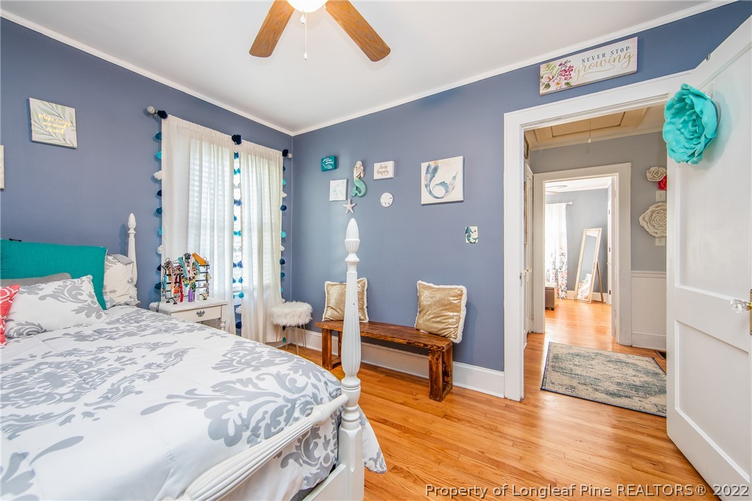 906 McKimmon Road Fayetteville, NC 28303 - Photo 27 of 33 a bedroom with a bed and wooden floor