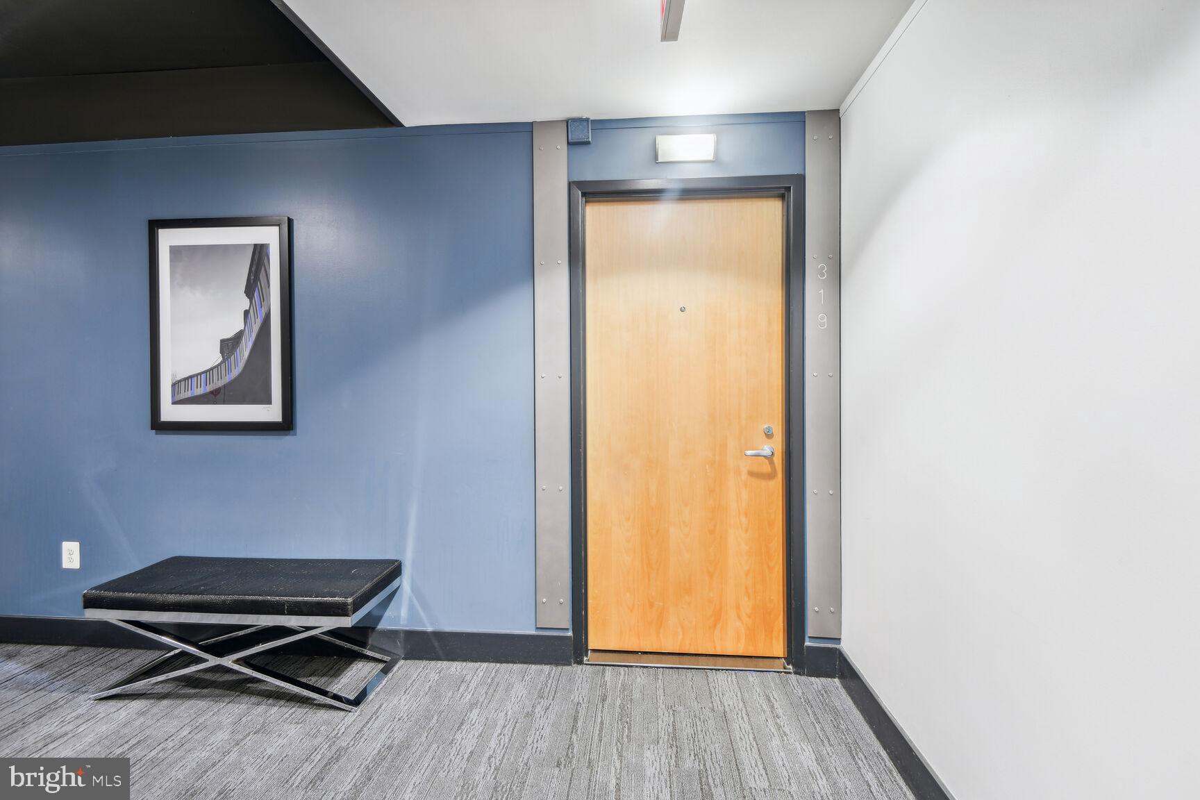 2125 14th Street Northwest, Unit 319 Washington, DC 20009 - Photo 2 of 23 a room with a door and wooden floor