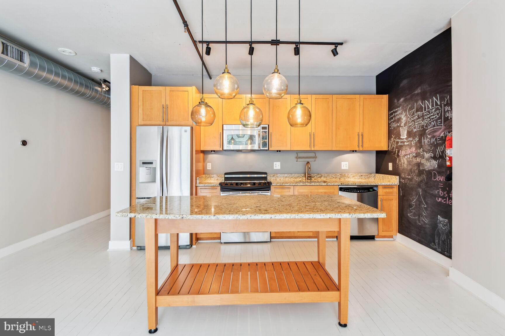 2125 14th Street Northwest, Unit 319 Washington, DC 20009 - Photo 4 of 23 a kitchen with a table chairs and a window