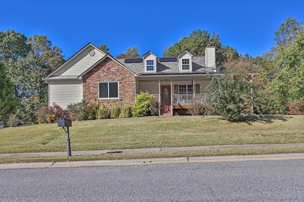 a front view of a house with a garden