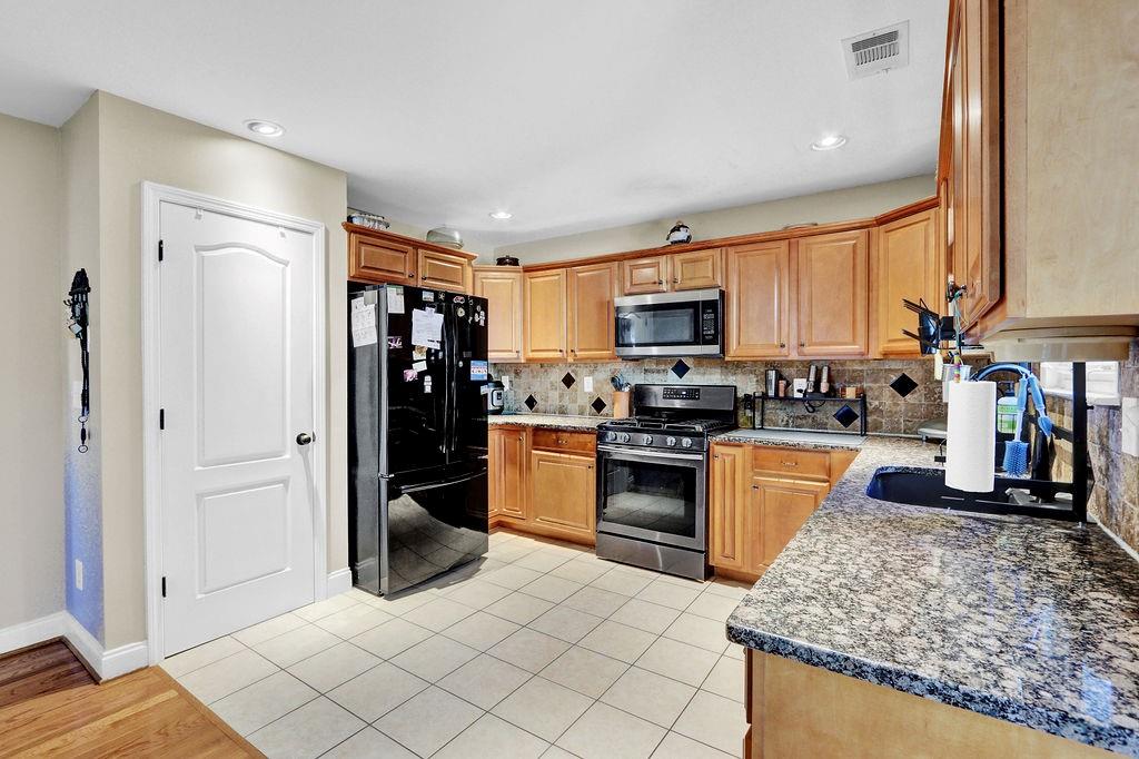 5636 River Stone Road Gainesville, GA 30506 - Photo 11 of 36 a kitchen with stainless steel appliances granite countertop a refrigerator and a stove top oven
