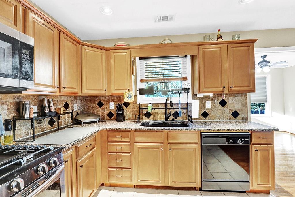 5636 River Stone Road Gainesville, GA 30506 - Photo 12 of 36 a kitchen with stainless steel appliances granite countertop a stove sink and cabinets