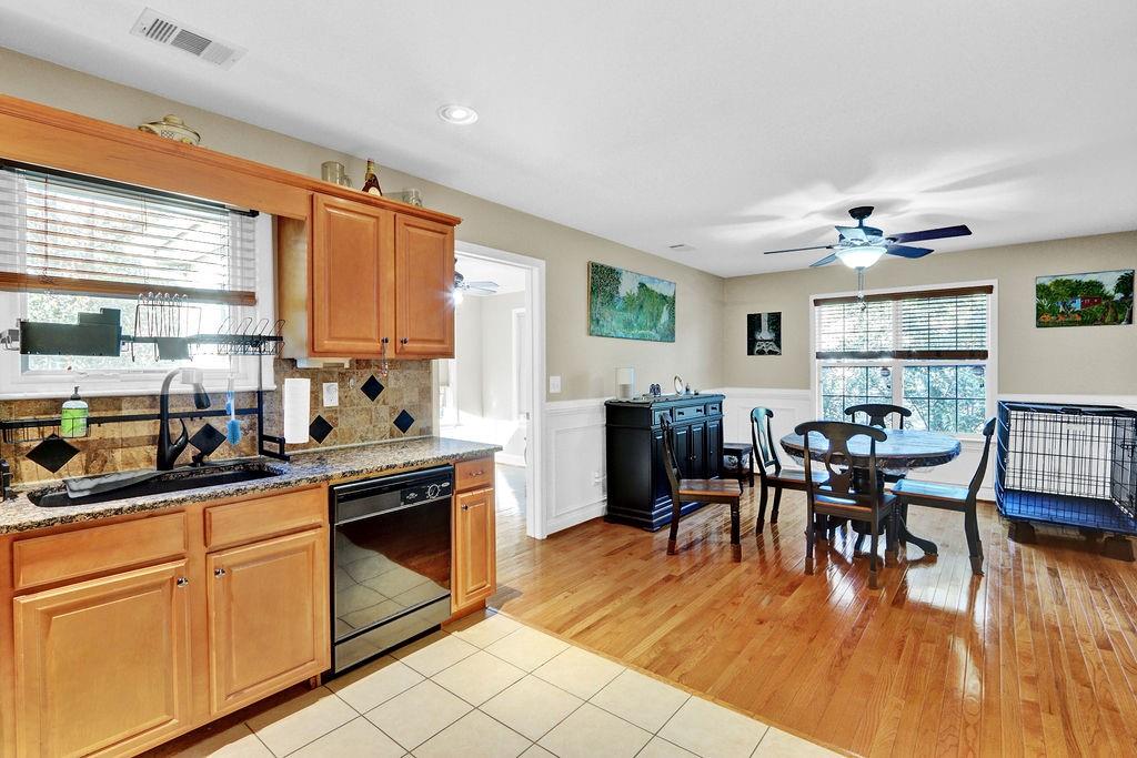 5636 River Stone Road Gainesville, GA 30506 - Photo 13 of 36 a dining hall with stainless steel appliances granite countertop a stove top oven a dining table and chairs with wooden floor