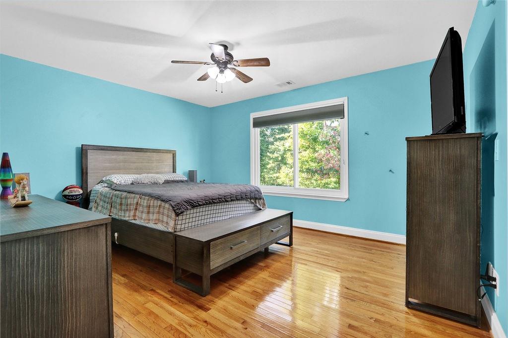 5636 River Stone Road Gainesville, GA 30506 - Photo 17 of 36 a bedroom with a bed and a flat screen tv