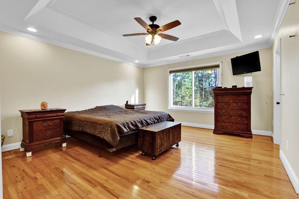5636 River Stone Road Gainesville, GA 30506 - Photo 18 of 36 a spacious bedroom with a bed and a flat screen tv