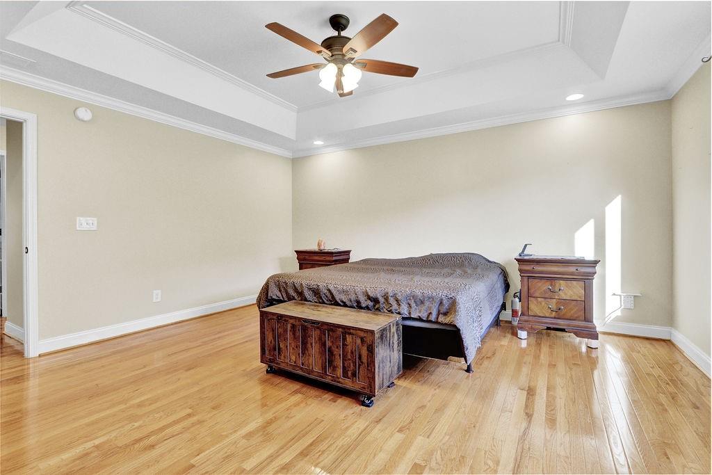 5636 River Stone Road Gainesville, GA 30506 - Photo 20 of 36 a living room with a bed furniture and a chandelier