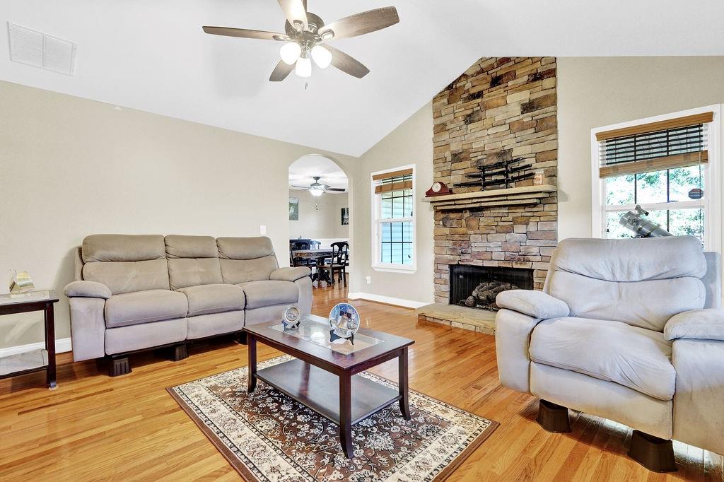 5636 River Stone Road Gainesville, GA 30506 - Photo 4 of 36 a living room with furniture a rug and a fireplace