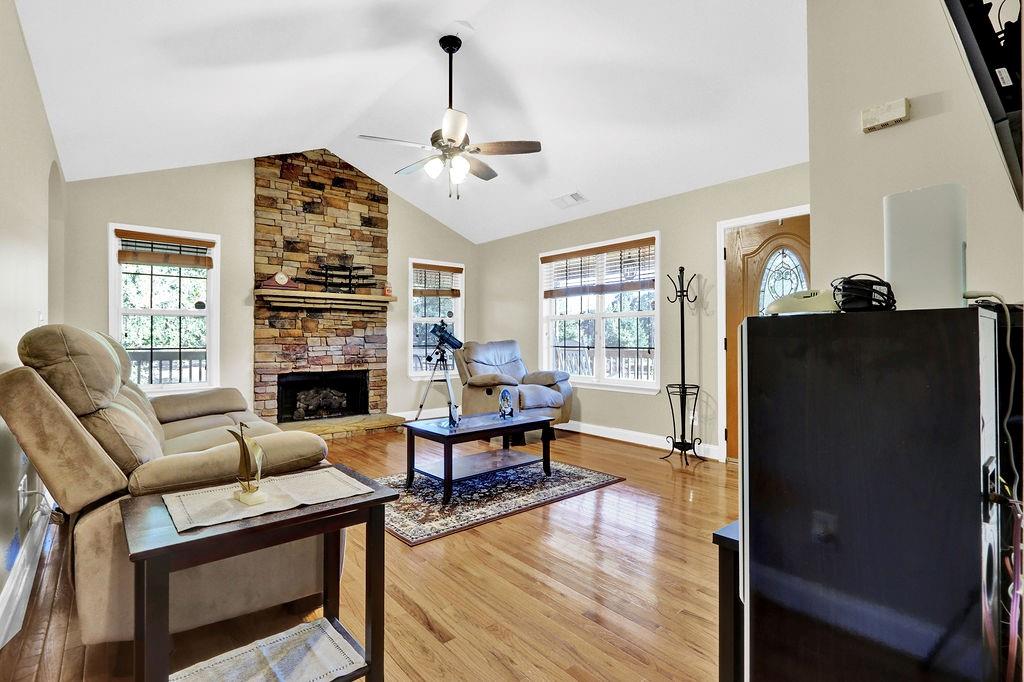 5636 River Stone Road Gainesville, GA 30506 - Photo 5 of 36 a living room with furniture a fireplace and a large window