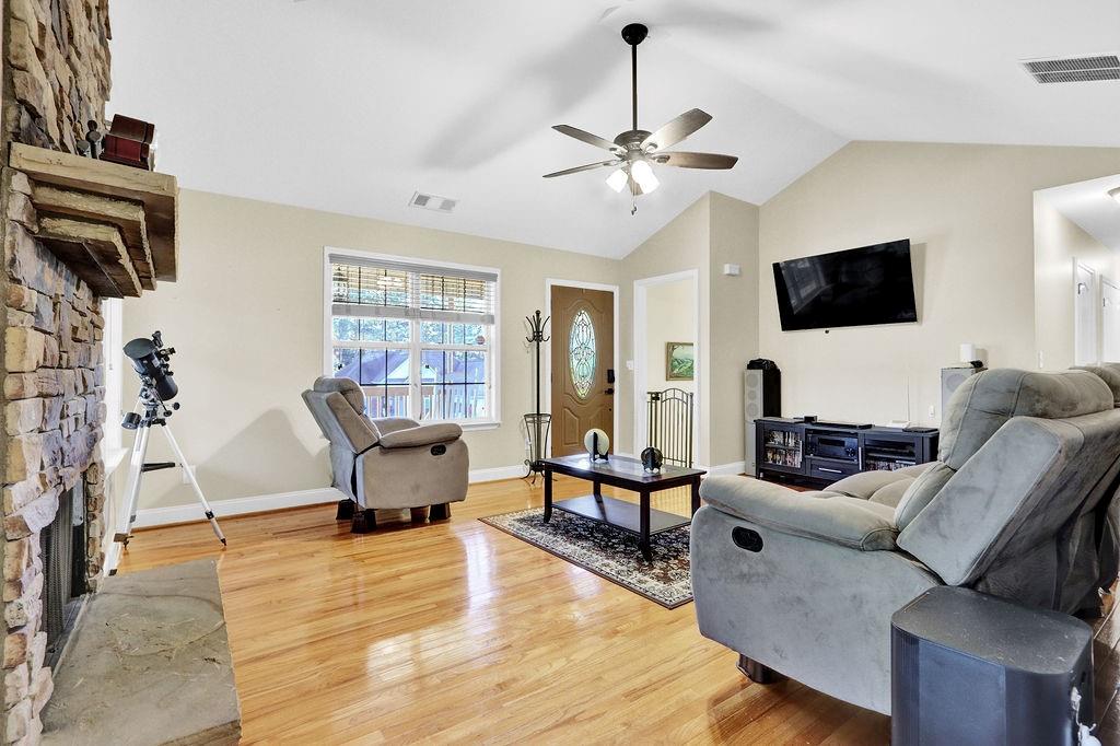 5636 River Stone Road Gainesville, GA 30506 - Photo 6 of 36 a living room with furniture and a flat screen tv