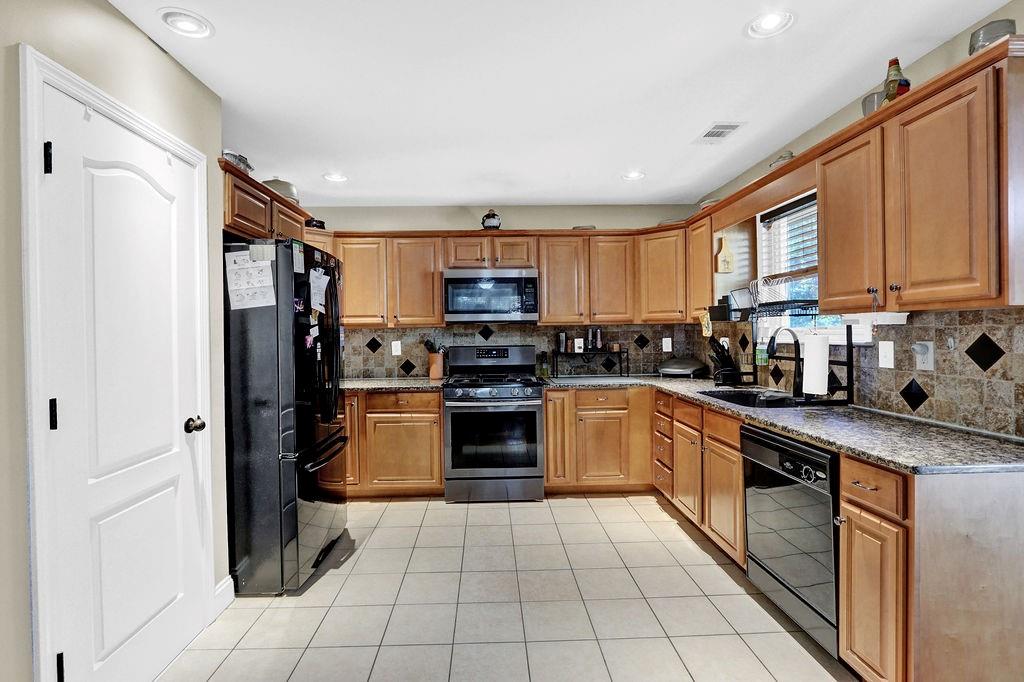 5636 River Stone Road Gainesville, GA 30506 - Photo 10 of 36 a kitchen with a refrigerator a sink and a stove top oven