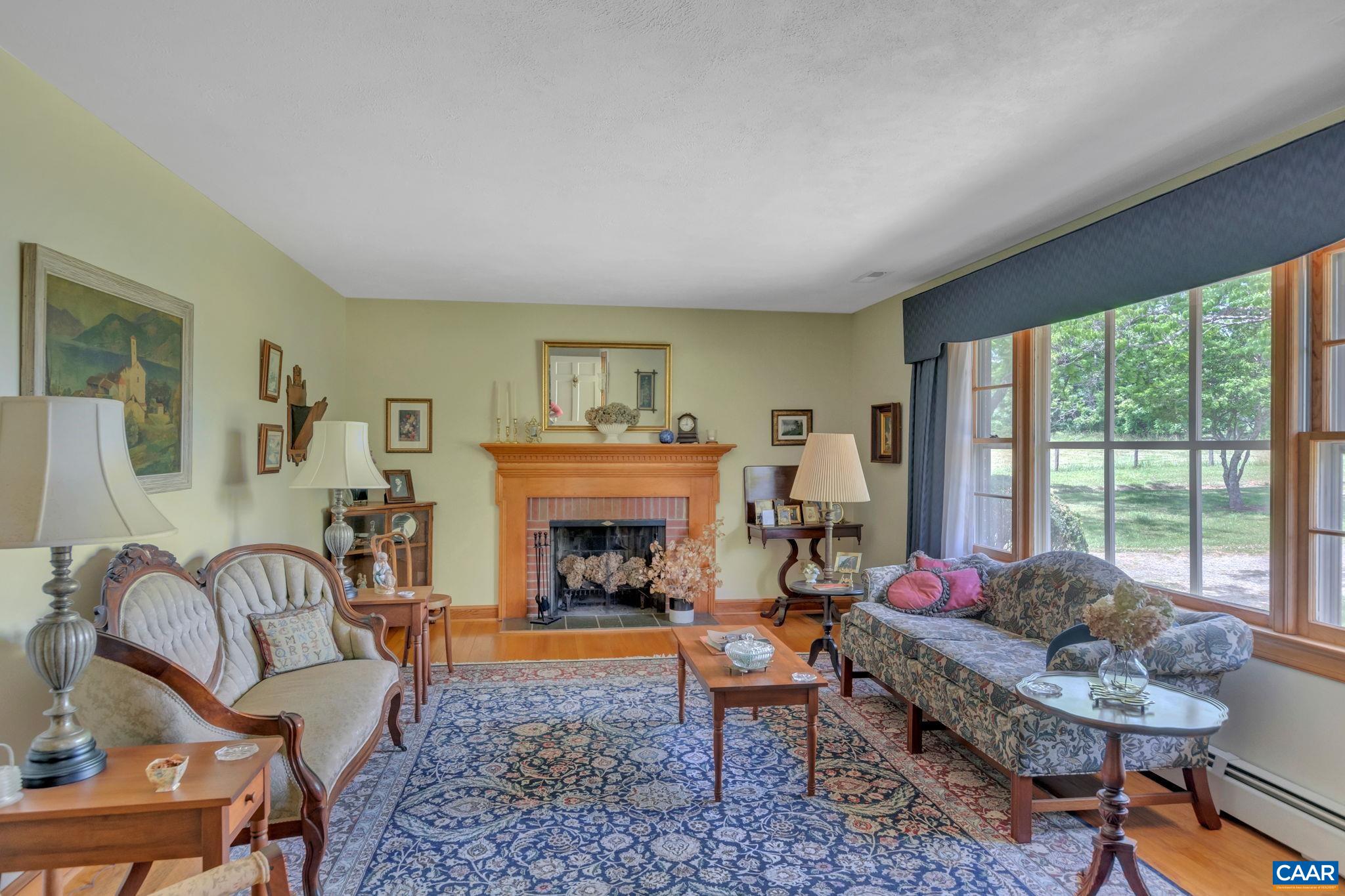 4459 Garth Road Charlottesville, VA 22901 - Photo 12 of 54 a living room with furniture and a fireplace