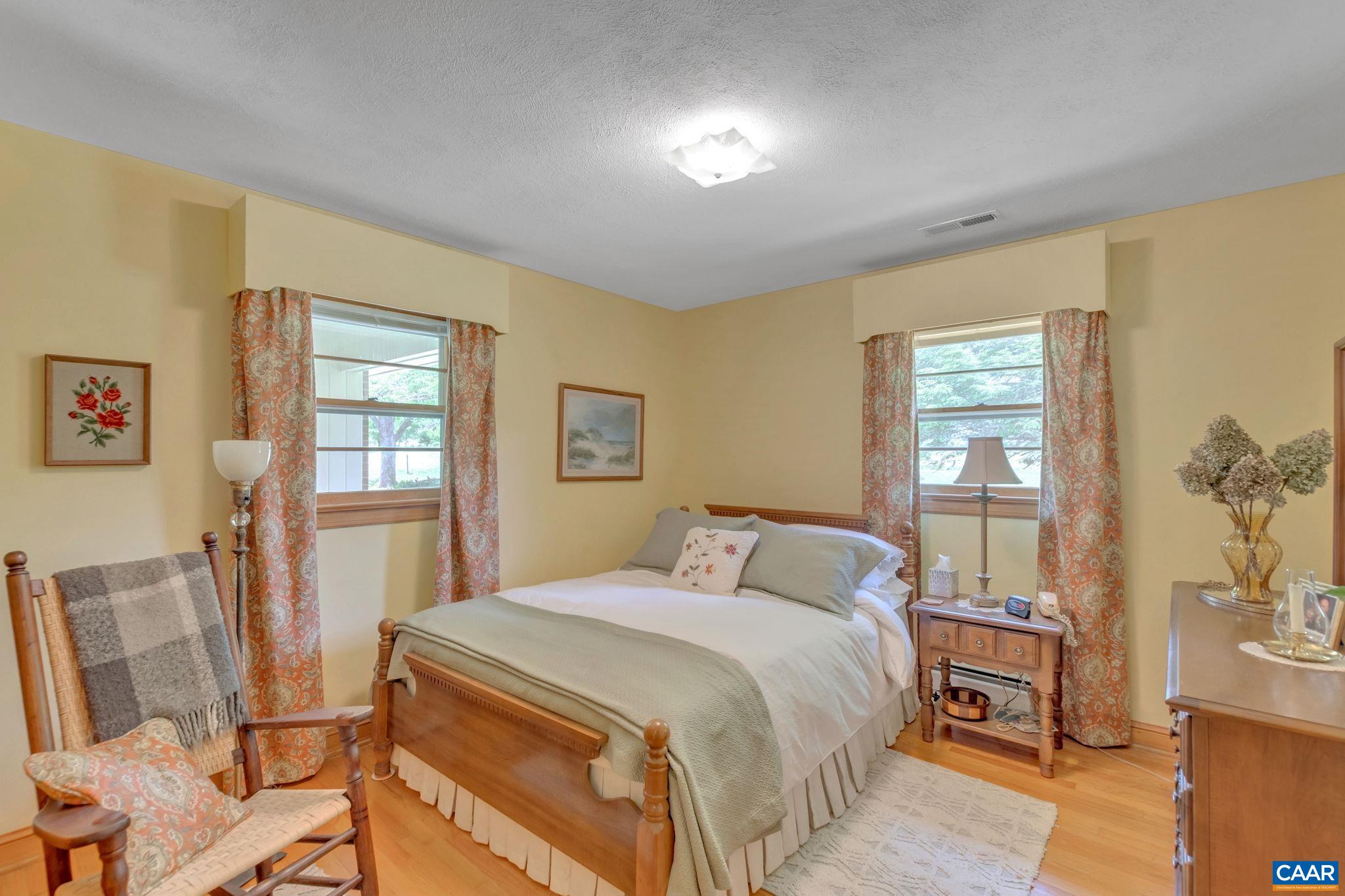 4459 Garth Road Charlottesville, VA 22901 - Photo 16 of 54 a bedroom with a bed and wooden floor