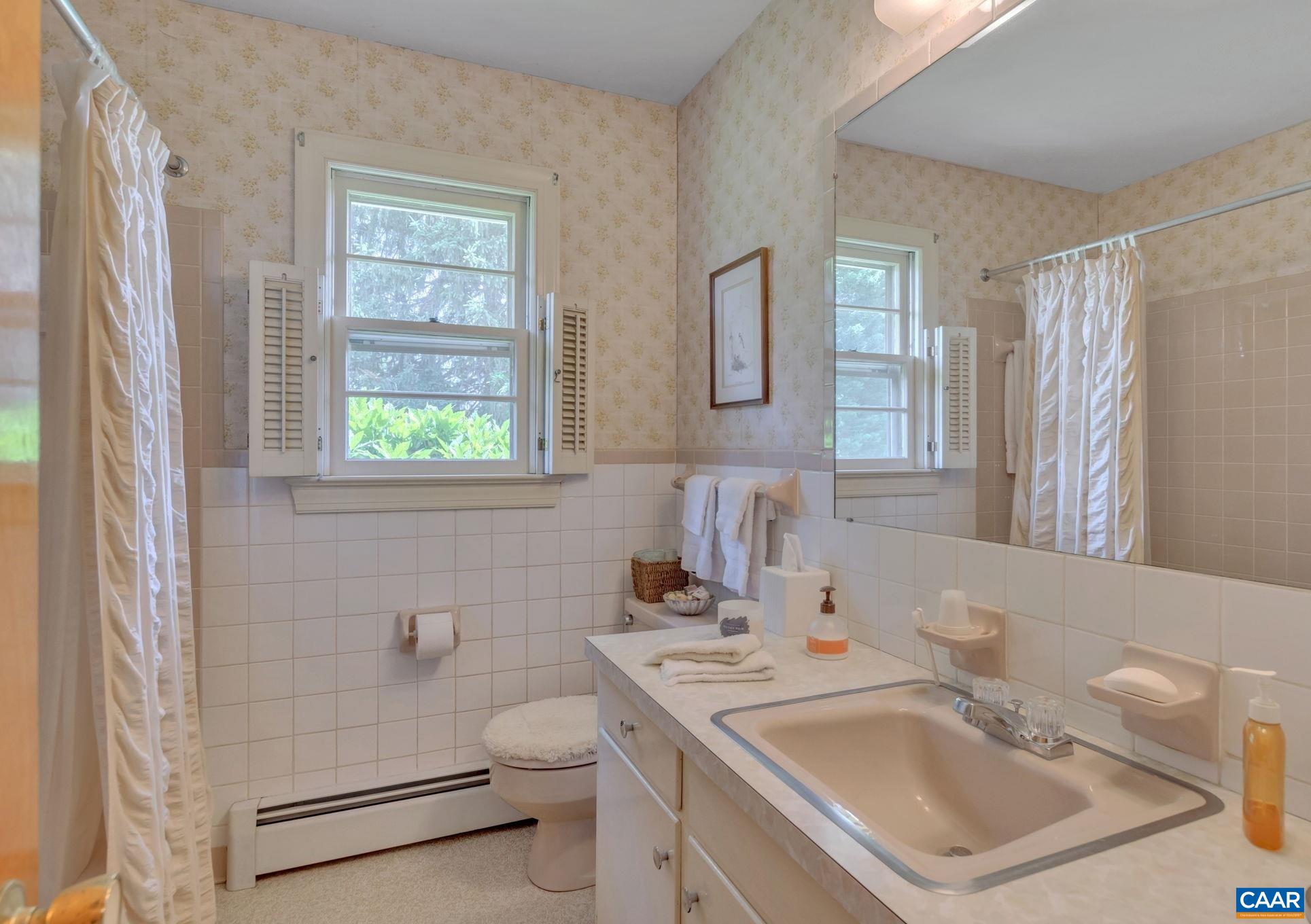 4459 Garth Road Charlottesville, VA 22901 - Photo 17 of 54 a bathroom with a sink toilet and shower