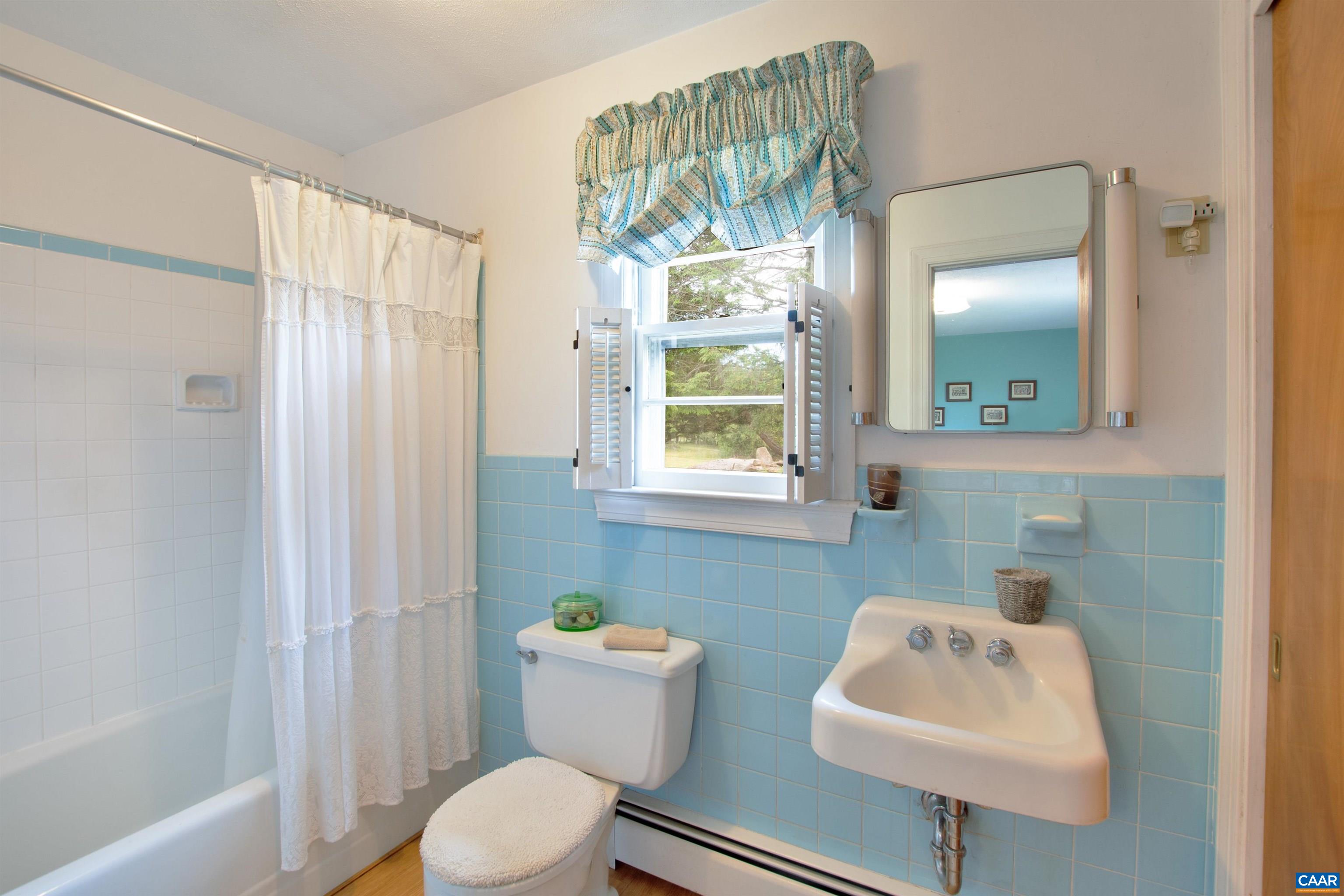 4459 Garth Road Charlottesville, VA 22901 - Photo 19 of 54 a bathroom with a sink toilet and mirror