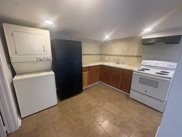 a kitchen with a stove sink and a refrigerator