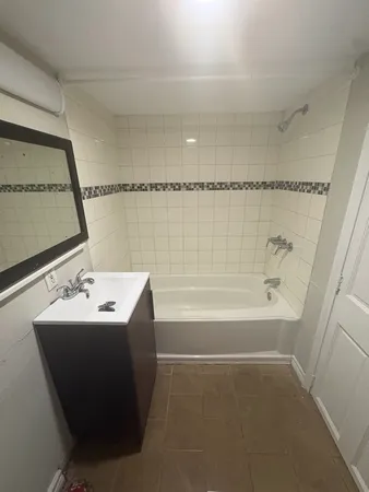 a bathroom with a sink a mirror and a bathtub