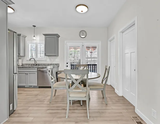 a dining room with furniture and wooden floor