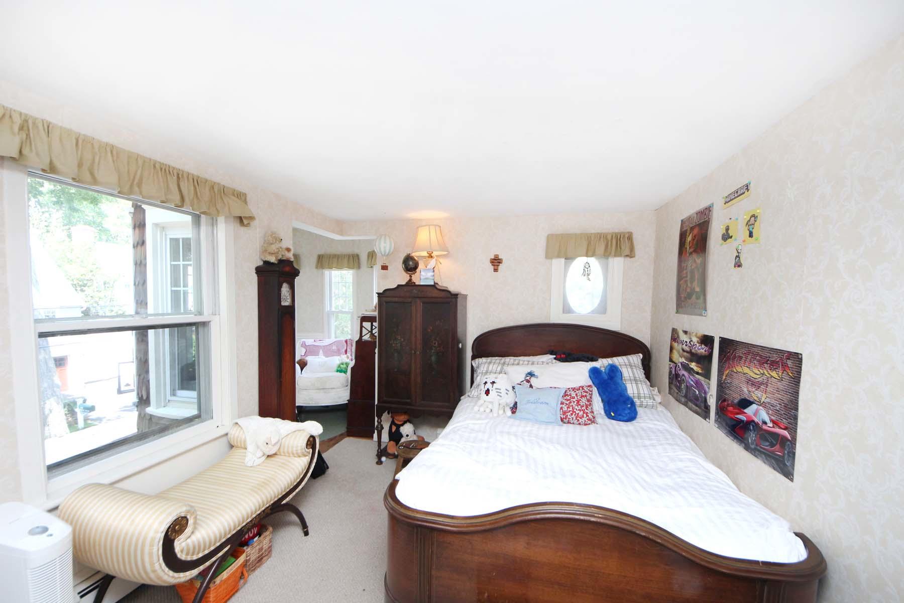 15 Ensign Road Rowayton, CT 06853 - Photo 16 of 21 a bedroom with a bed and wooden floor