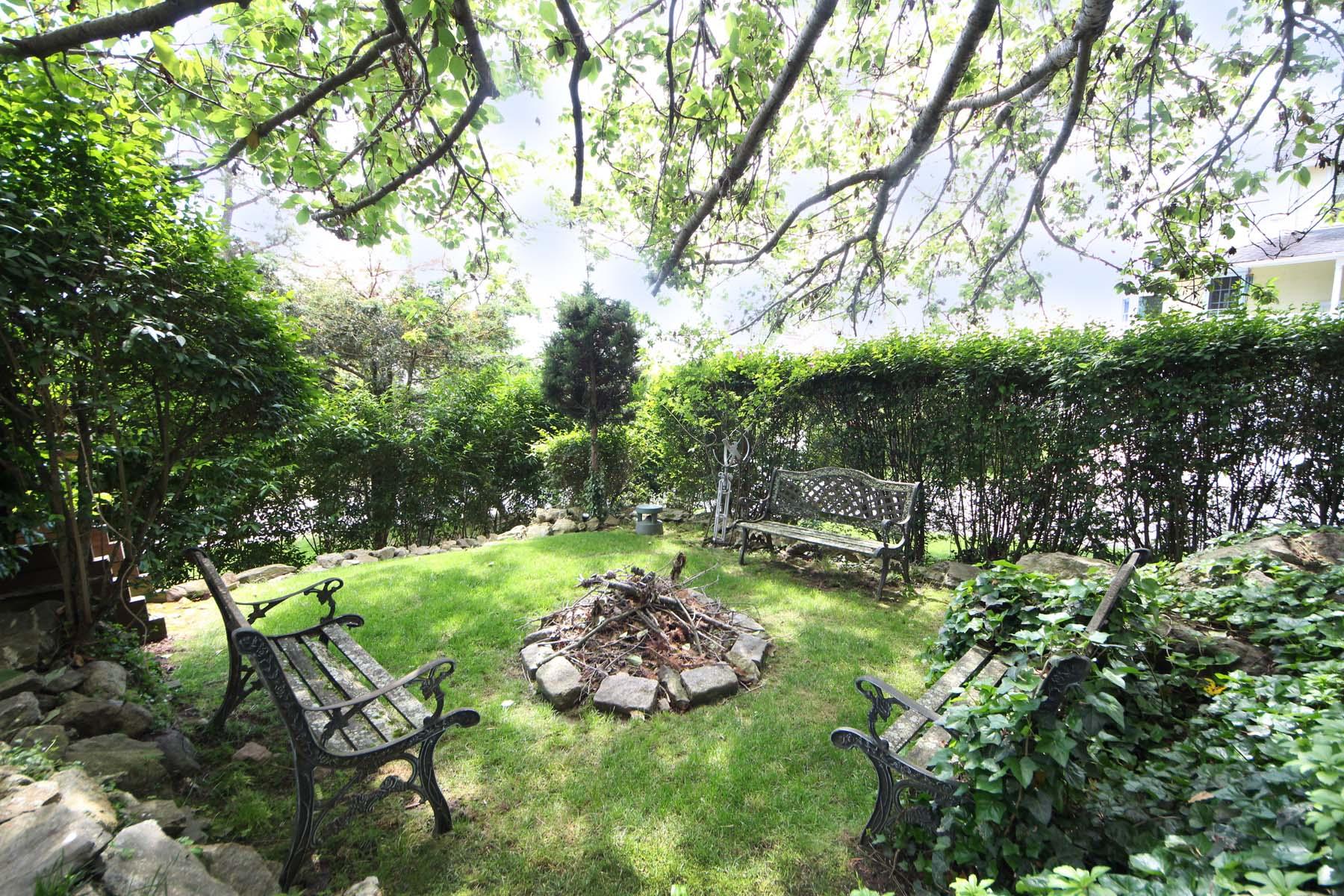 15 Ensign Road Rowayton, CT 06853 - Photo 4 of 21 a view of a backyard with table and chairs and large trees