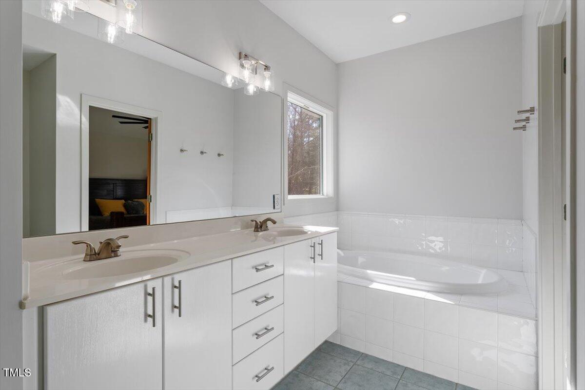 5920 Orchid Valley Road Raleigh, NC 27613 - Photo 35 of 54 Owner's Bathroom with dual sinks and relaxing sunken tub