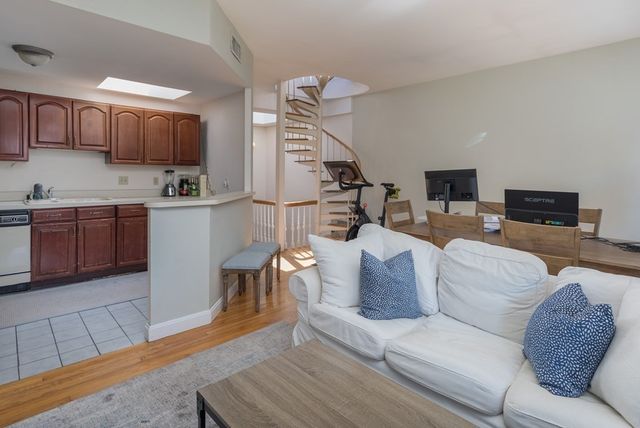 a living room with furniture a wooden floor and a sink