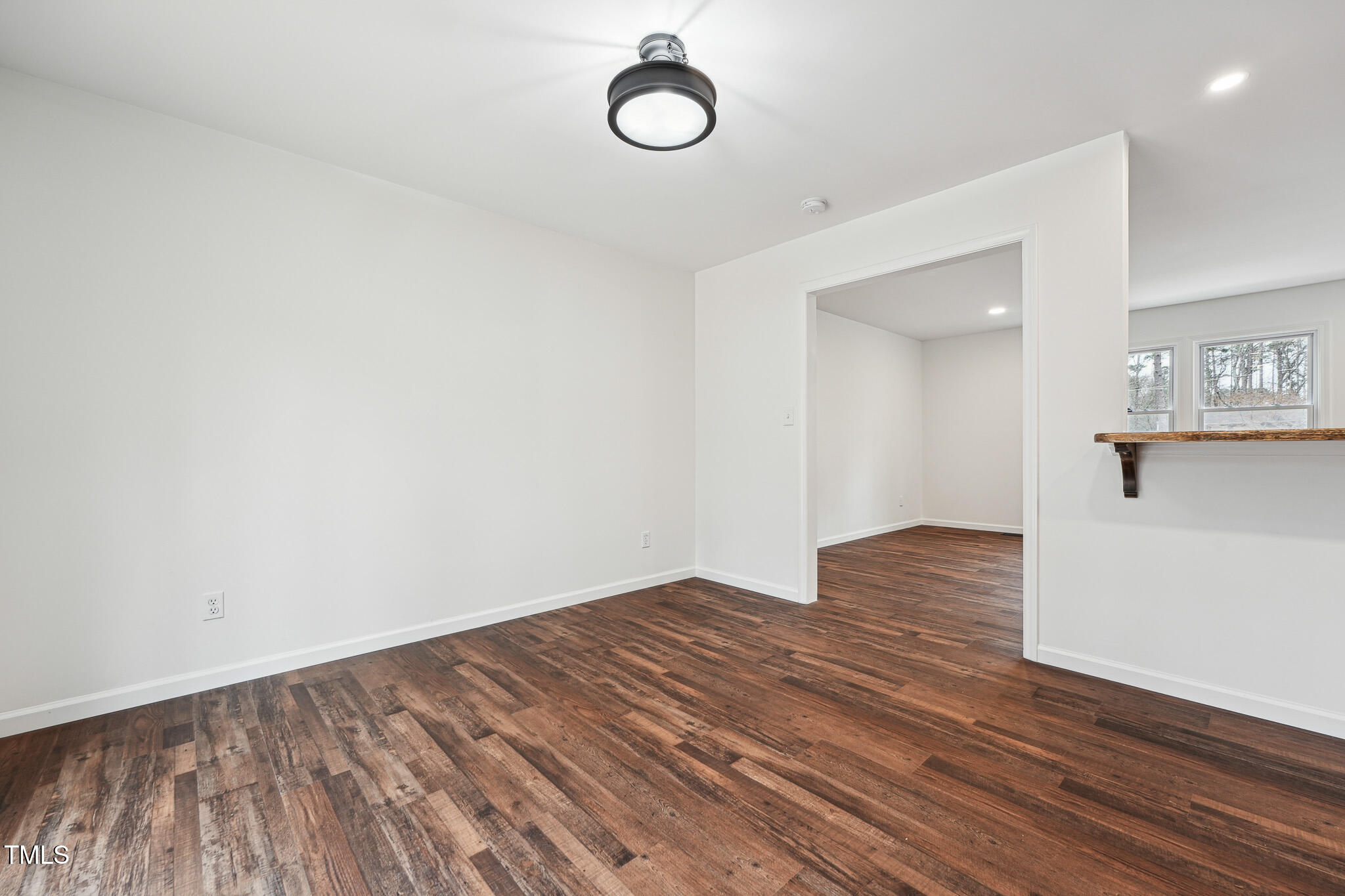 109 Chatterson Drive Raleigh, NC 27615 - Photo 11 of 51 a view of a room with wooden floor and white walls
