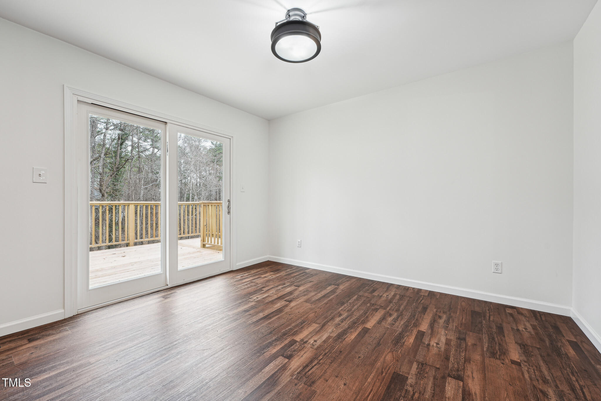 109 Chatterson Drive Raleigh, NC 27615 - Photo 12 of 51 a view of an empty room with wooden floor and a window