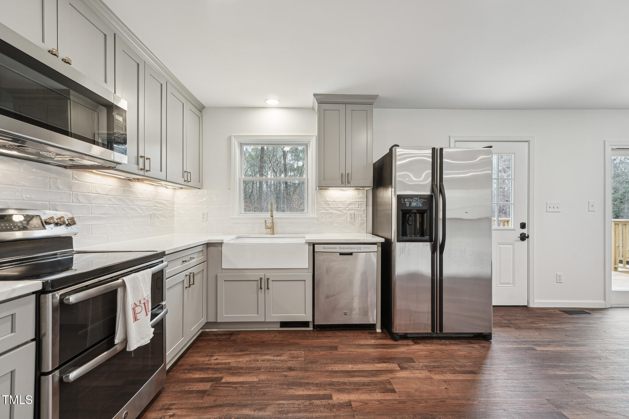 109 Chatterson Drive Raleigh, NC 27615 - Photo 14 of 51 a kitchen with stainless steel appliances a refrigerator sink and microwave