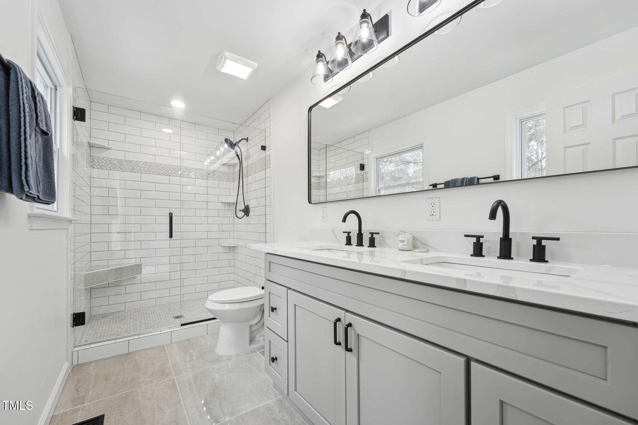 109 Chatterson Drive Raleigh, NC 27615 - Photo 21 of 51 a bathroom with a double vanity sink toilet and a mirror