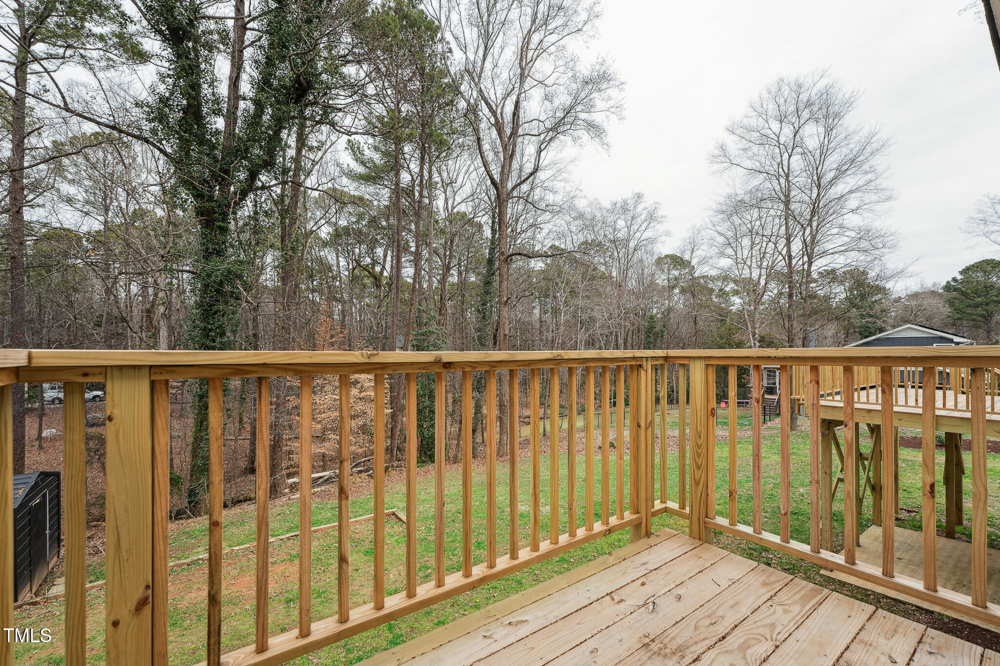 109 Chatterson Drive Raleigh, NC 27615 - Photo 23 of 51 a balcony with wooden floor and fence