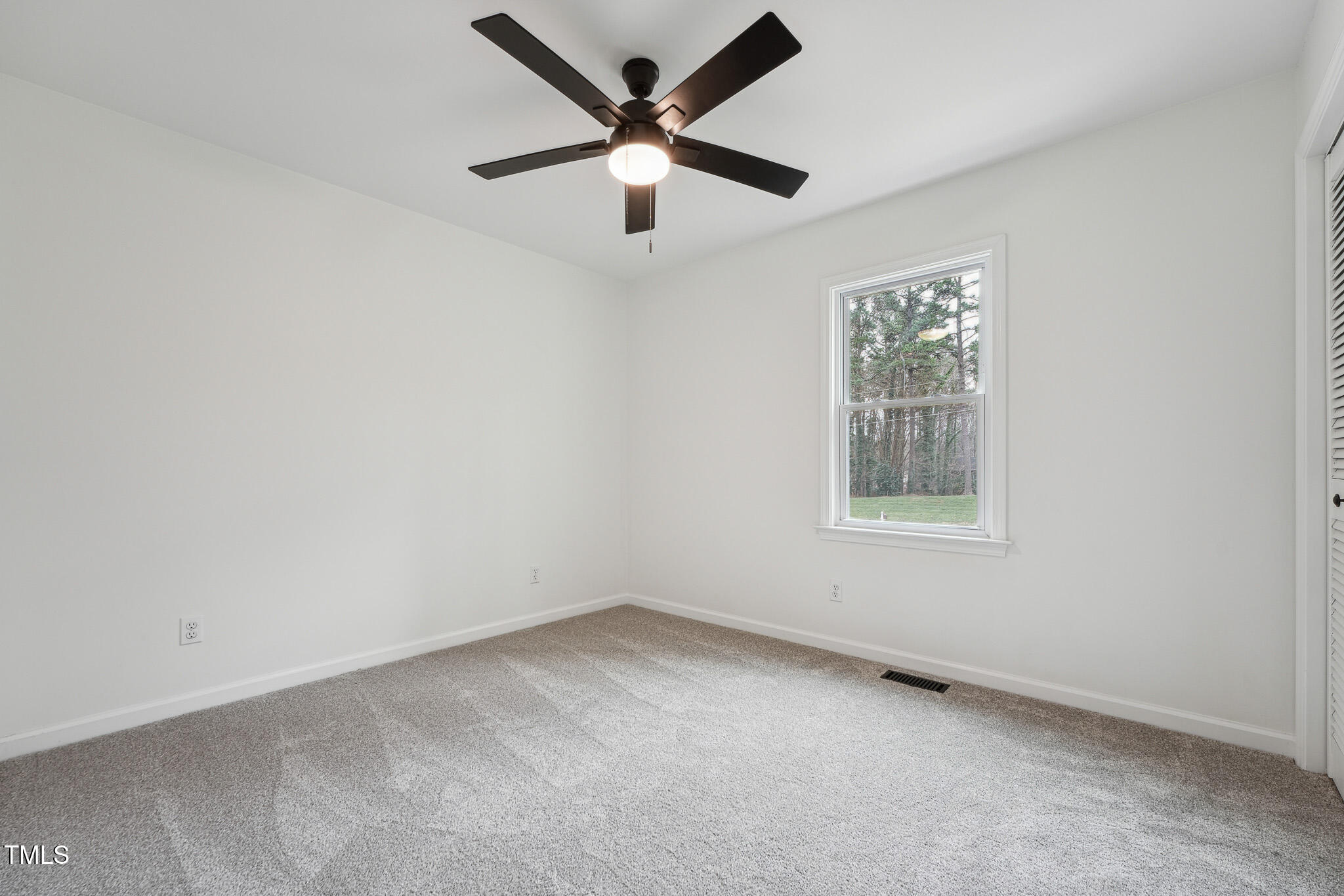 109 Chatterson Drive Raleigh, NC 27615 - Photo 24 of 51 an empty room with a window and a fan