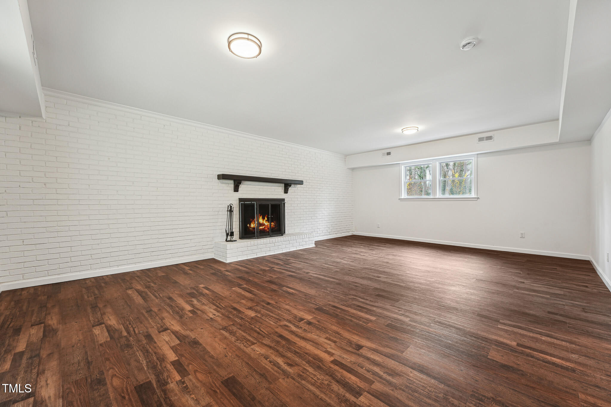 109 Chatterson Drive Raleigh, NC 27615 - Photo 28 of 51 a view of empty room with wooden floor and fireplace