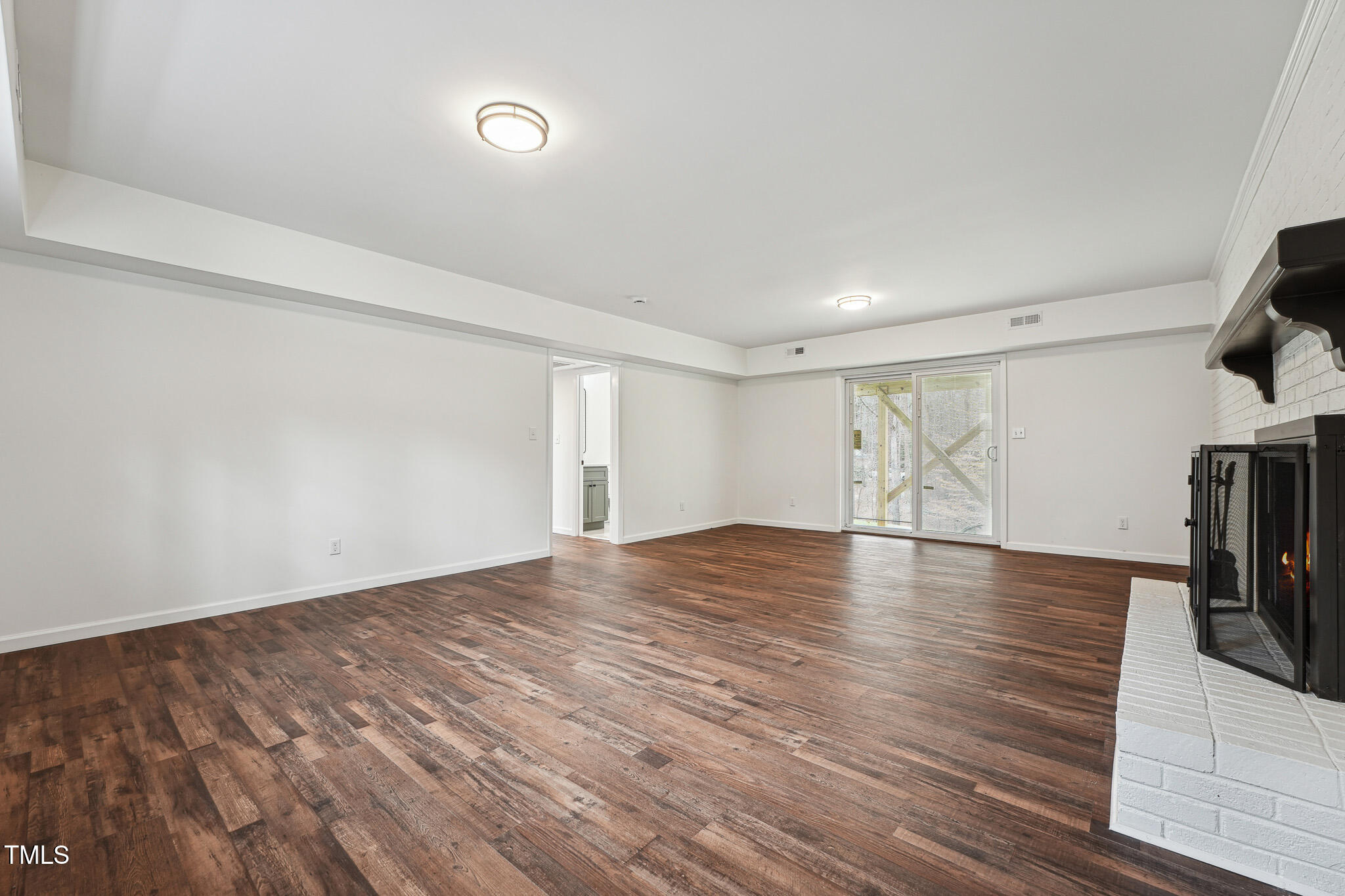 109 Chatterson Drive Raleigh, NC 27615 - Photo 30 of 51 a view of empty room with wooden floor and fan