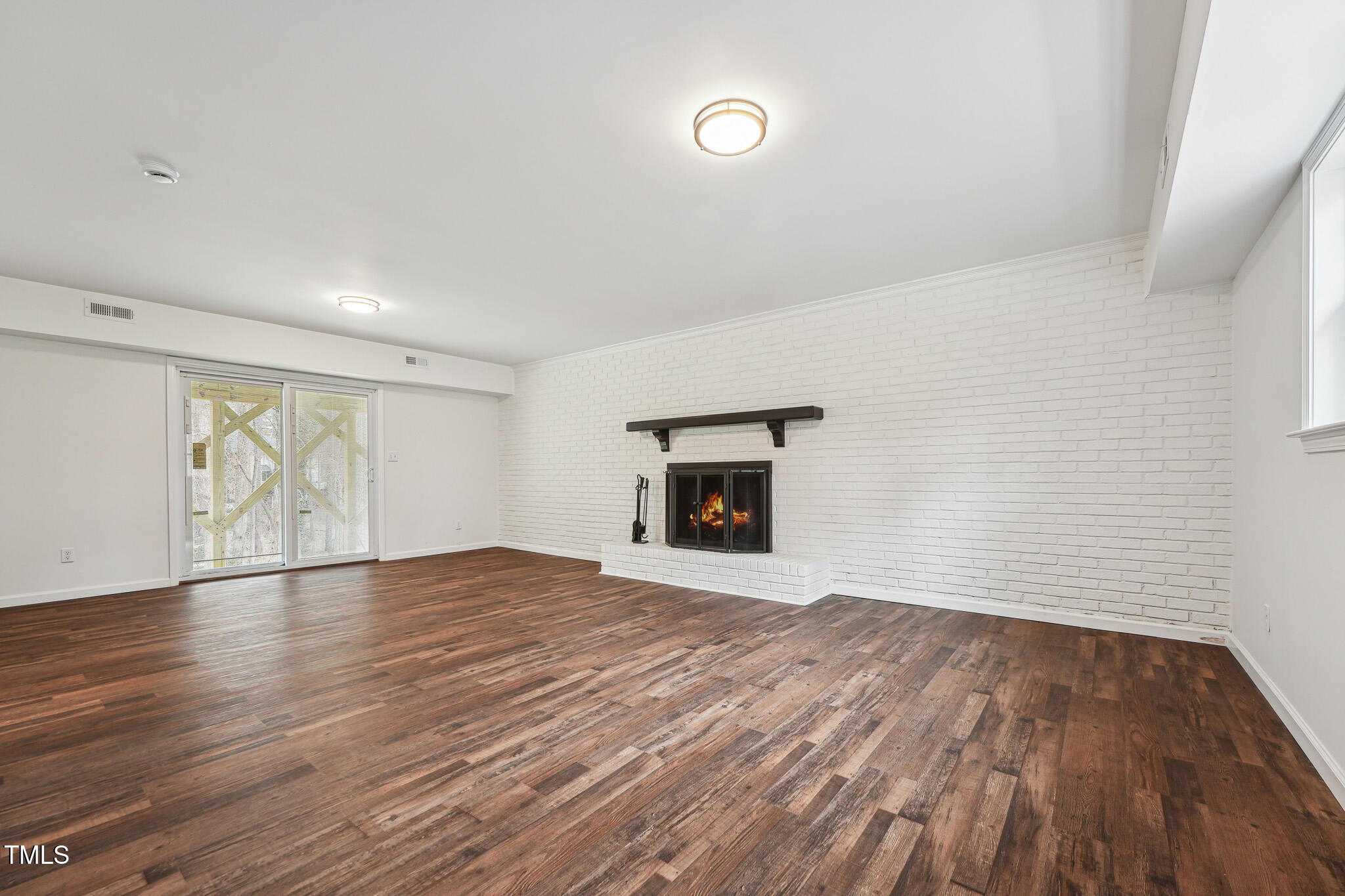 109 Chatterson Drive Raleigh, NC 27615 - Photo 31 of 51 a view of empty room with wooden floor and fireplace