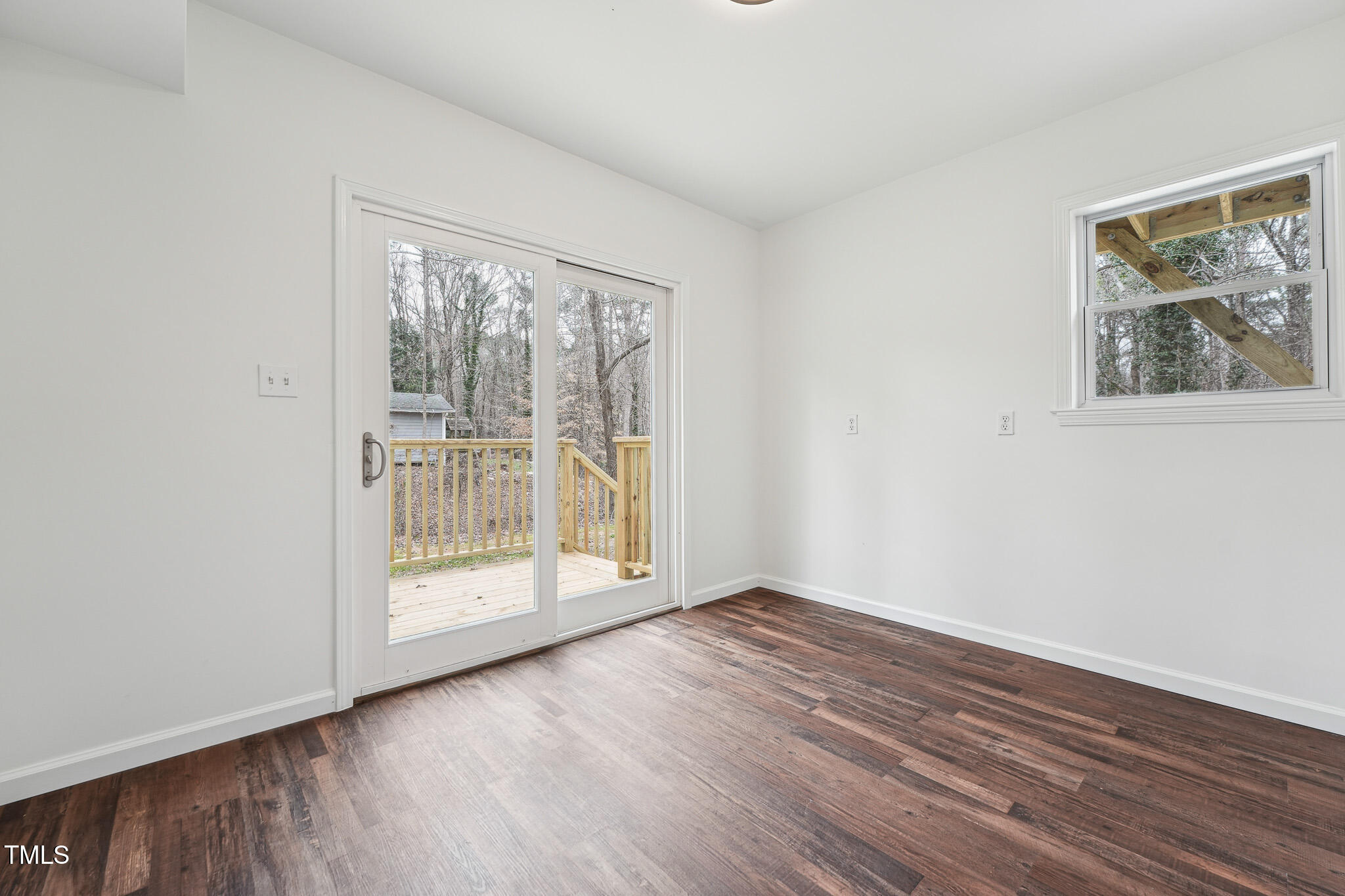 109 Chatterson Drive Raleigh, NC 27615 - Photo 33 of 51 an empty room with wooden floor and windows