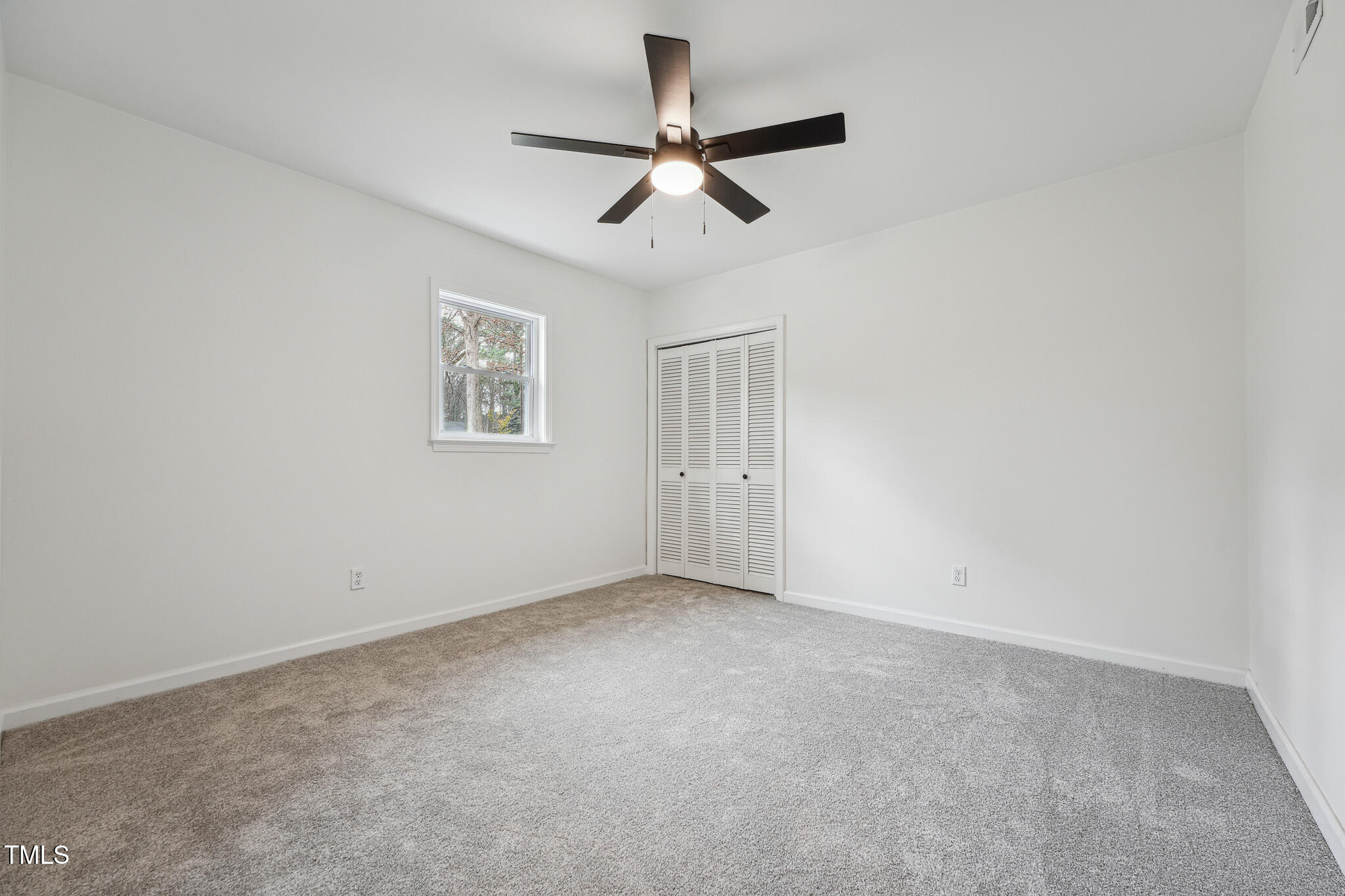 109 Chatterson Drive Raleigh, NC 27615 - Photo 35 of 51 an empty room with a window and a fan