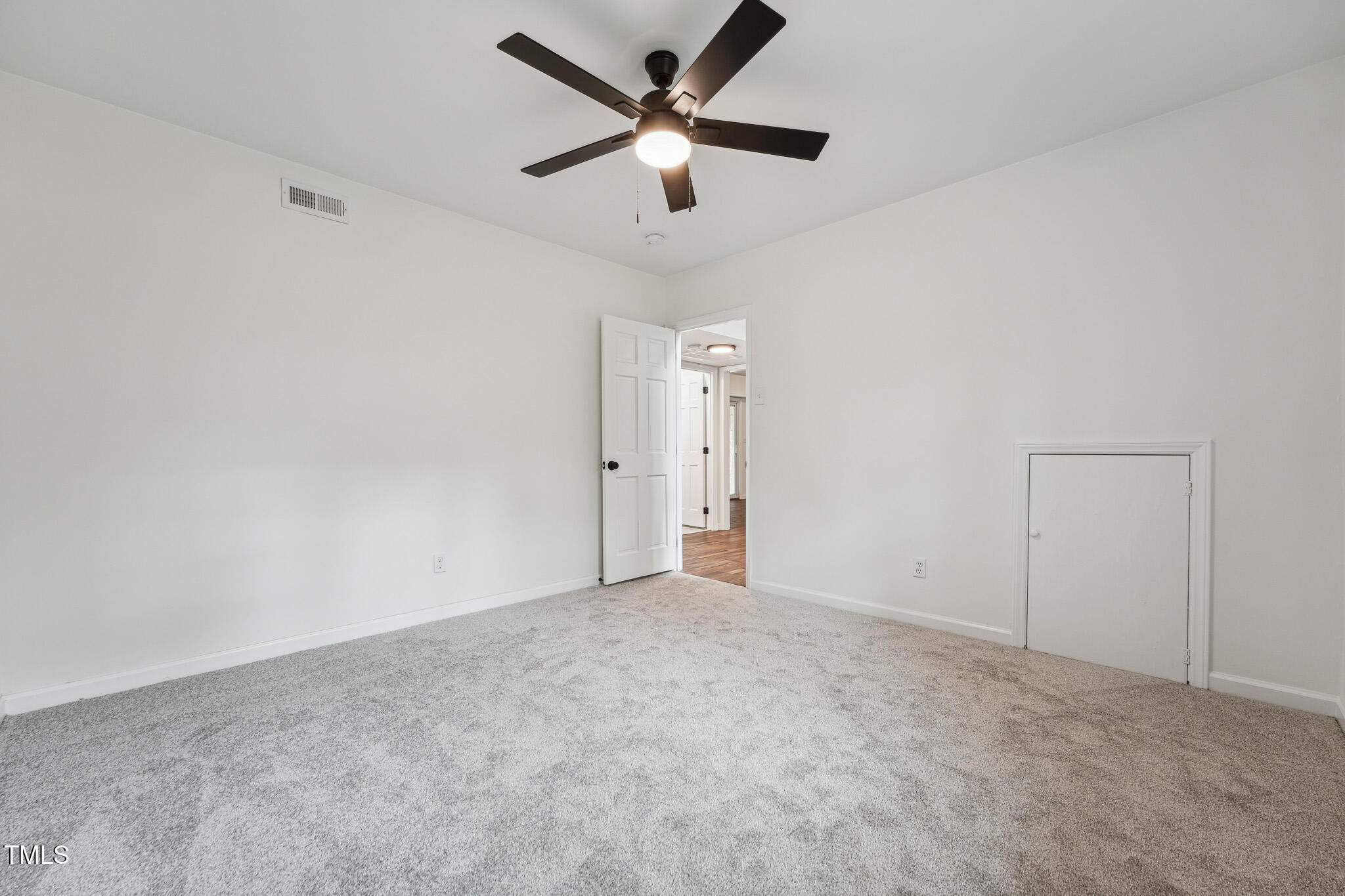 109 Chatterson Drive Raleigh, NC 27615 - Photo 36 of 51 an empty room with closet and fan