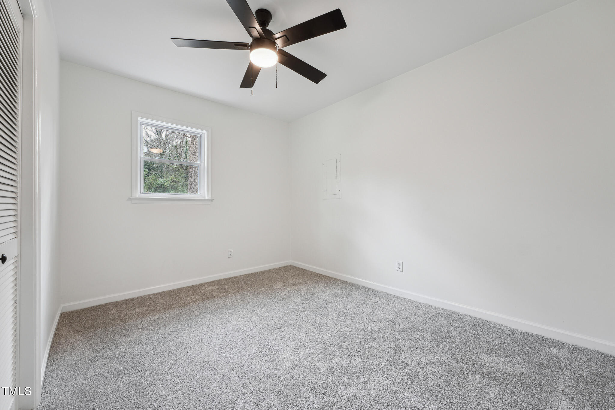 109 Chatterson Drive Raleigh, NC 27615 - Photo 38 of 51 an empty room with a window and a fan